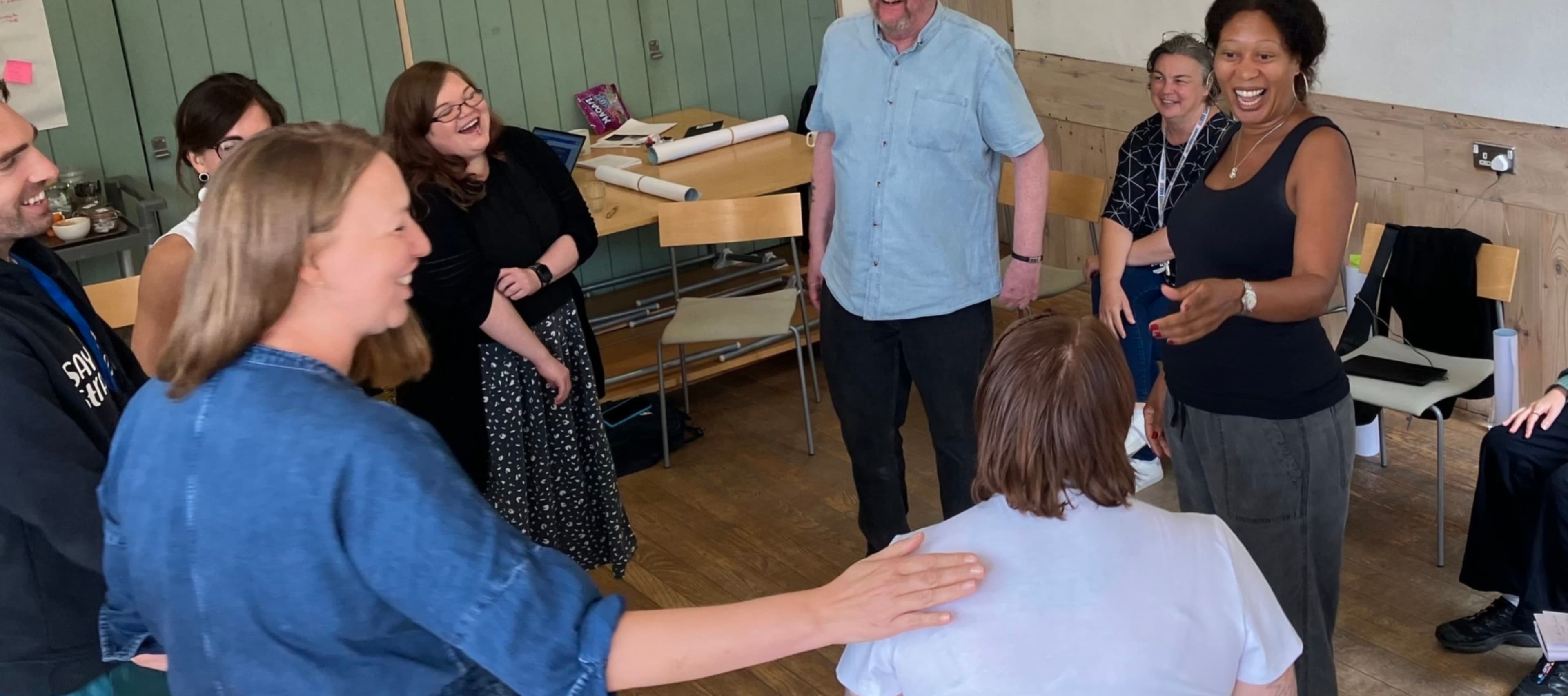 Group of people smiling in a circle