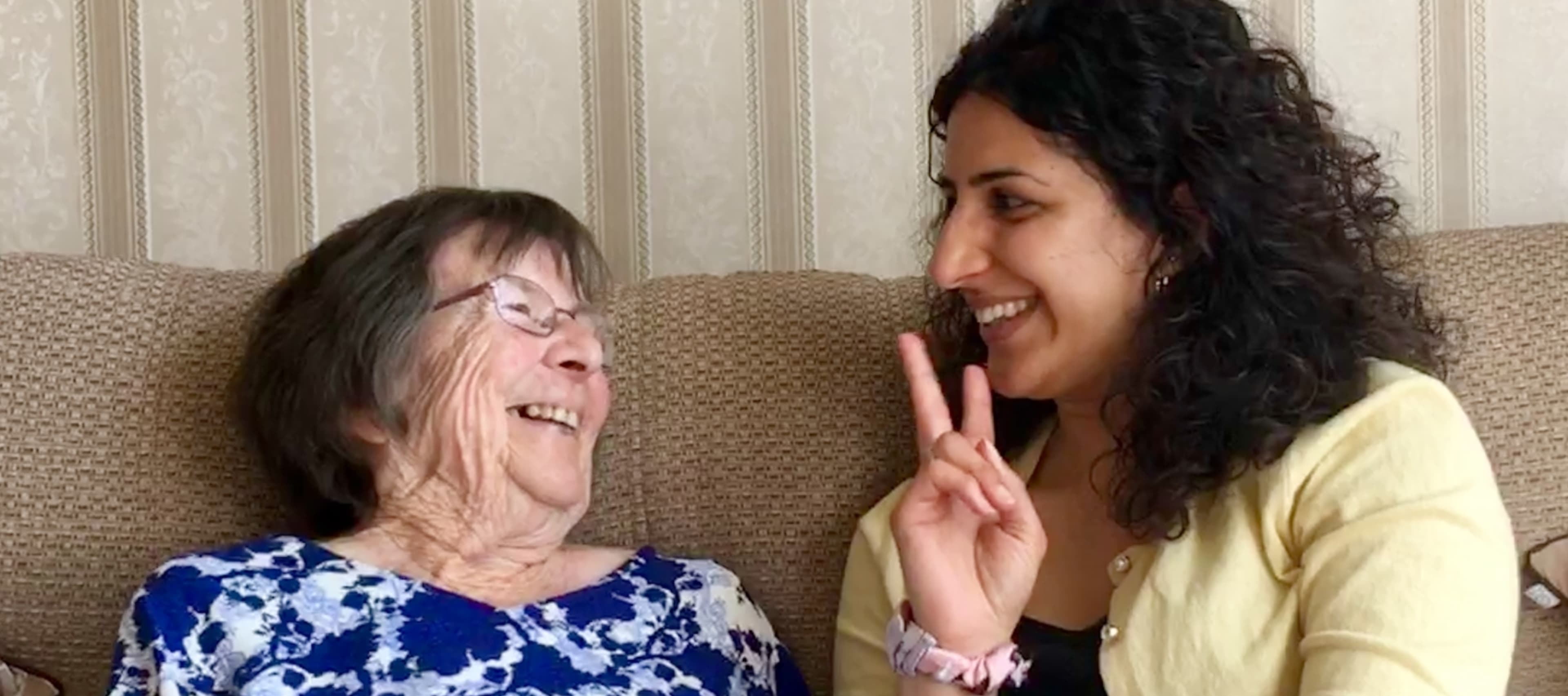 Two women smiling at each other