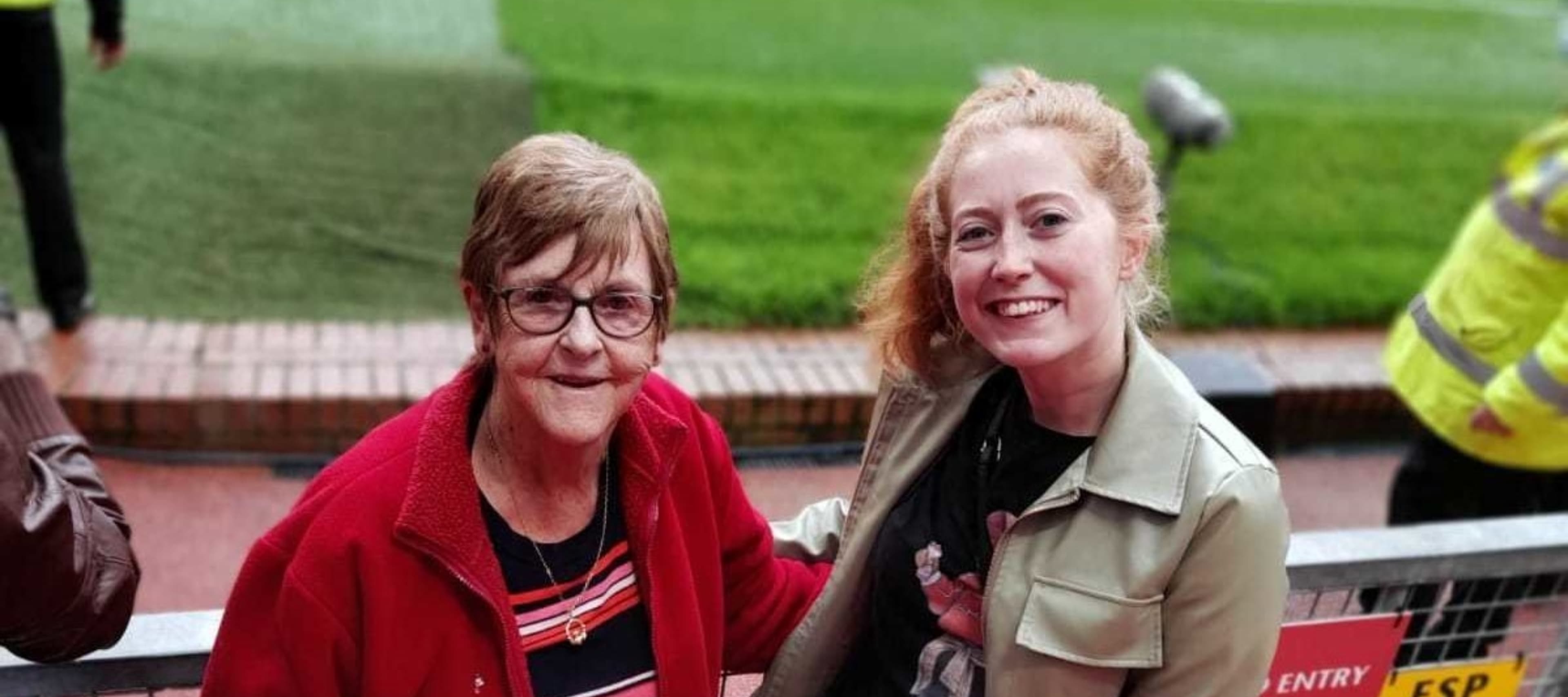 An older and younger neighbour at a football match
